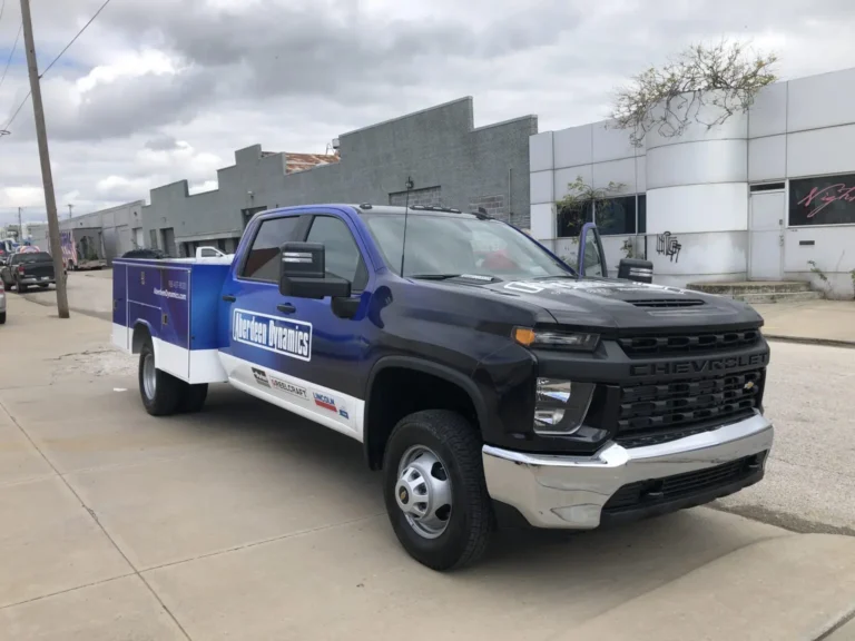 Chevrolet work truck with blue fleet graphics and company logo